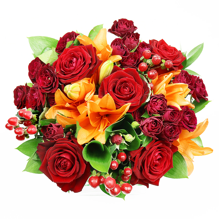 Luxurious and vibrant, this bouquet is captured from directly above, set against a pristine white backdrop. The arrangement is densely packed and perfectly rounded, overflowing with a magnificent blend of deep red roses, bright orange lilies, and clusters of dark red spray roses. Prominently featured are several large, fully bloomed red roses, their velvety petals unfurling to create a sense of classic romance and passion. Interspersed throughout are numerous smaller, tightly budded burgundy spray roses, adding depth and a jewel-toned accent. Providing a striking contrast and a burst of warmth are orange lilies, easily identifiable by their trumpet-shaped petals and visible stamens, some fully open and others partially unfurled, hinting at a fresh bloom. Lush green foliage, including broad, glossy leaves (likely salal or similar), peeks out from between the blossoms, providing a vibrant backdrop and enhancing the natural beauty of the arrangement. Adding festive texture are scattered clusters of small, round, glossy red Hypericum berries, which punctuate the design with cheerful pops of color. This exquisite composition, a classic symbol of love, joy, and celebration, is artfully arranged to create an eye-catching display. The vibrant palette of reds, oranges, and greens forms a harmonious, visually captivating bouquet, perfect for gifting, home décor, or marking a special occasion.

Nestled in the riverside bustle of London's East End, near Wapping's narrow streets and the glow of the Thames, such a bouquet would lift a room with confident warmth. The bold reds and oranges glow in soft daylight, echoing lantern-lit evenings along Shad Thames and the docks, while the greenery adds breath and balance to the design.

Created by a seasoned local florist, it comes ready for same-day delivery across Wapping and the surrounding districts, ideal for birthdays, anniversaries, or a generous expression of gratitude that turns any space into a celebration.